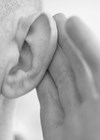 Photo showing person cupping ear to hear something.